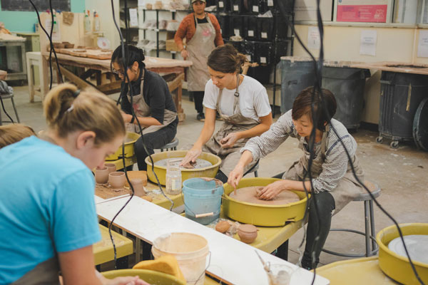 pottery classes people on the wheel - ceramics